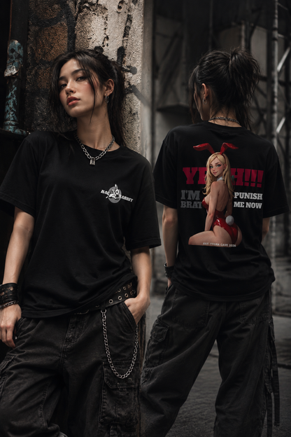 Two models wearing black graphic t-shirts in an urban alley setting. The model on the left shows the front of the shirt, which has a small white graphic on the left chest.